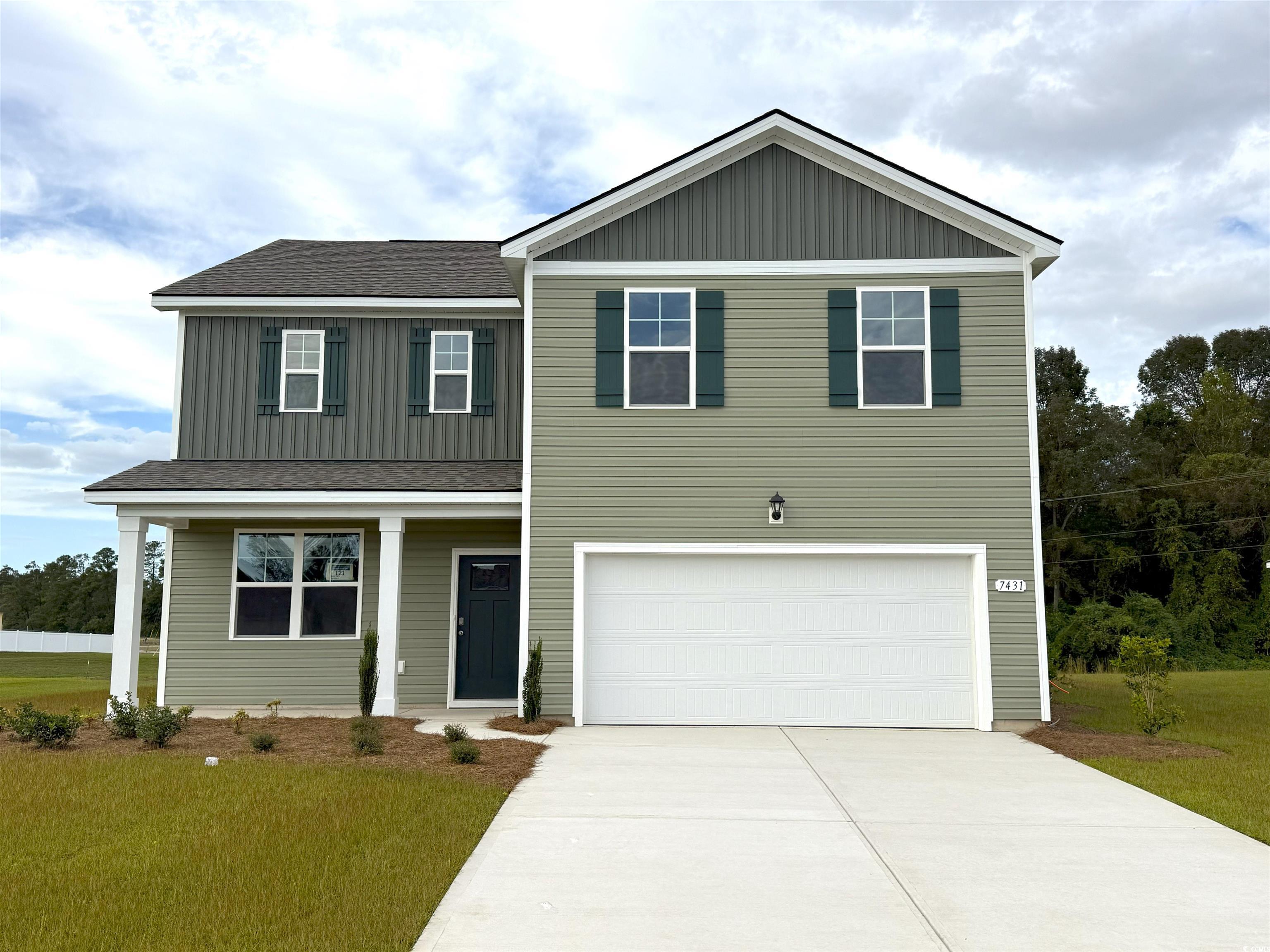 View of front of home featuring a porch, board and batten siding, a garage, and concrete driveway