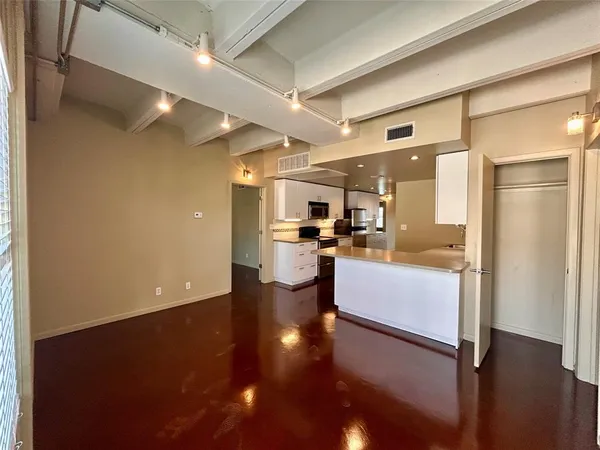 a kitchen with a refrigerator and a stove top oven