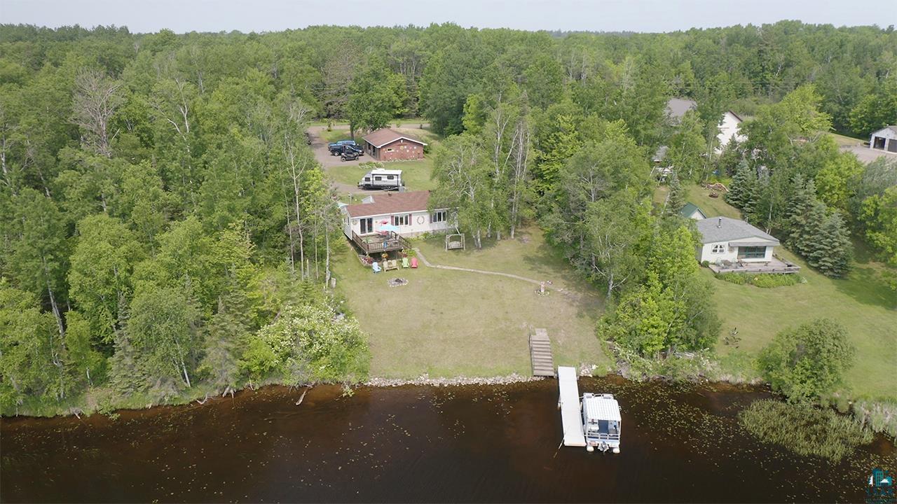 Aerial view of a heavily wooded area and a large body of water