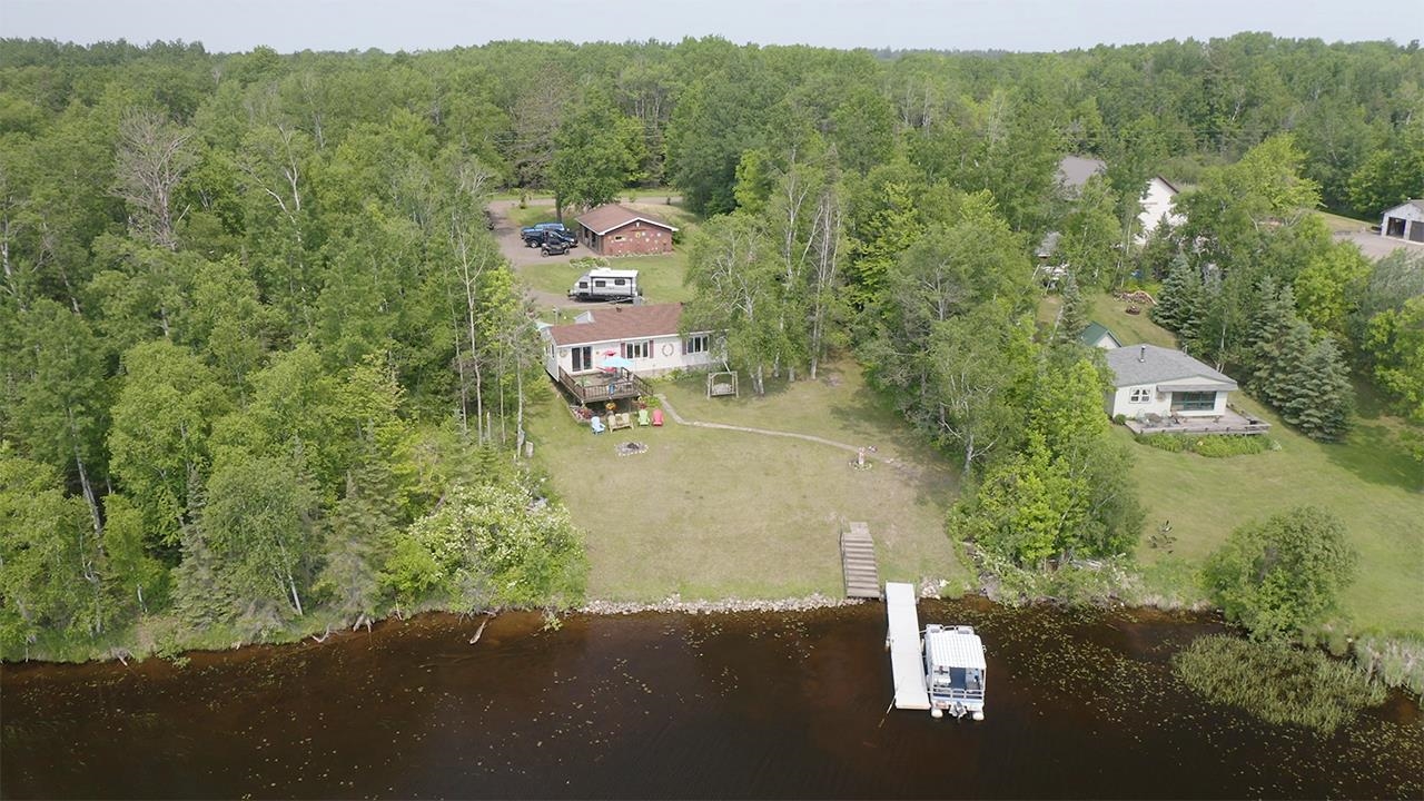 Aerial view of a heavily wooded area and a large body of water