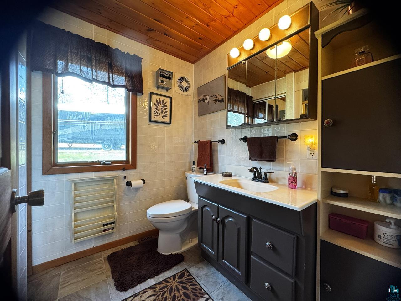 1198 West Mink Road Cotton, MN 55724 - Photo 13 of 23 Bathroom featuring wooden ceiling, vanity, and tile patterned flooring