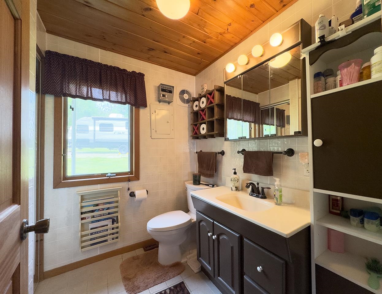 1198 West Mink Road Cotton, MN 55724 - Photo 13 of 23 Bathroom featuring wooden ceiling, vanity, and tile patterned flooring
