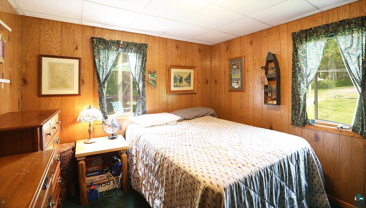 1198 West Mink Road Cotton, MN 55724 - Photo 15 of 23 Bedroom with wood walls and a paneled ceiling