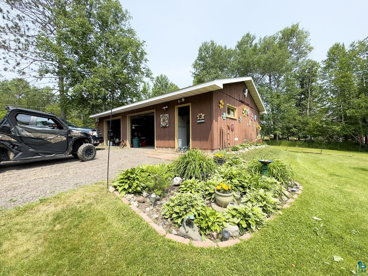 1198 West Mink Road Cotton, MN 55724 - Photo 17 of 23 View of front of home with an outbuilding and a front lawn