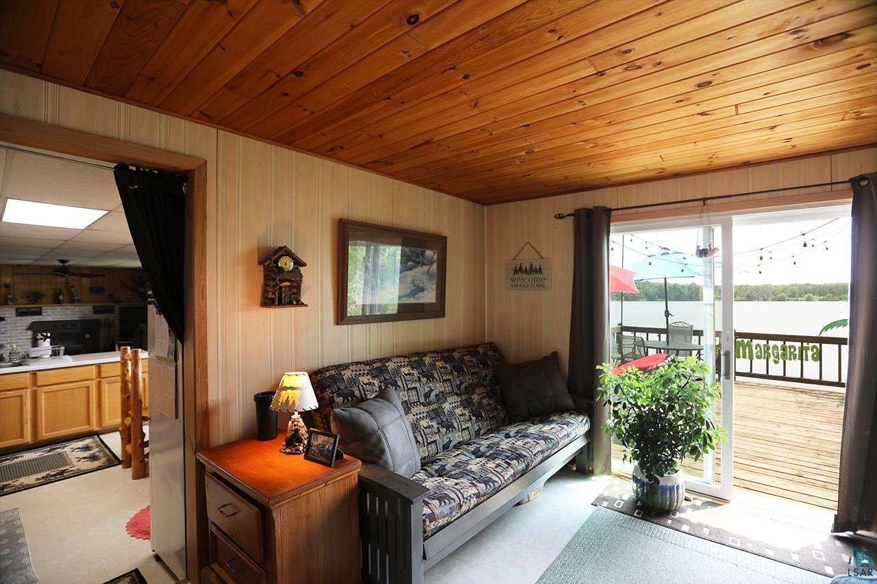1198 West Mink Road Cotton, MN 55724 - Photo 3 of 23 Living area with a water view, wood walls, and wood ceiling