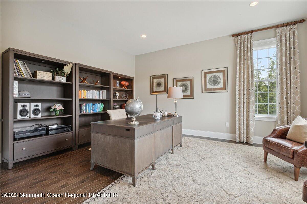 25 Windermere Road Lincroft, NJ 07738 - Photo 25 of 70 a living room with furniture and a bookshelf