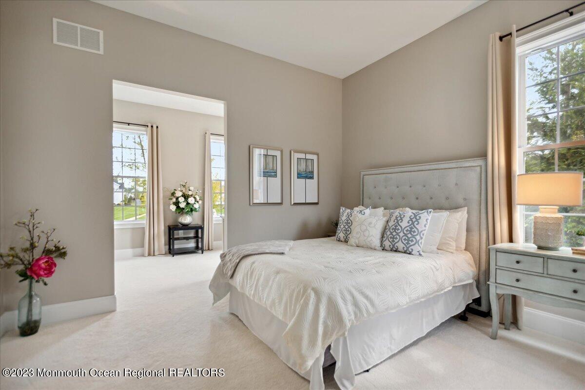 25 Windermere Road Lincroft, NJ 07738 - Photo 27 of 70 a bedroom with a large bed and potted plant