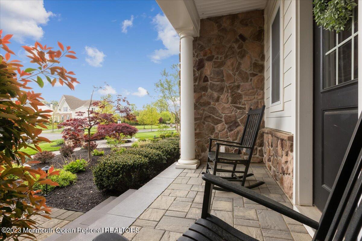 25 Windermere Road Lincroft, NJ 07738 - Photo 3 of 70 a view of a balcony with wooden floor and bench