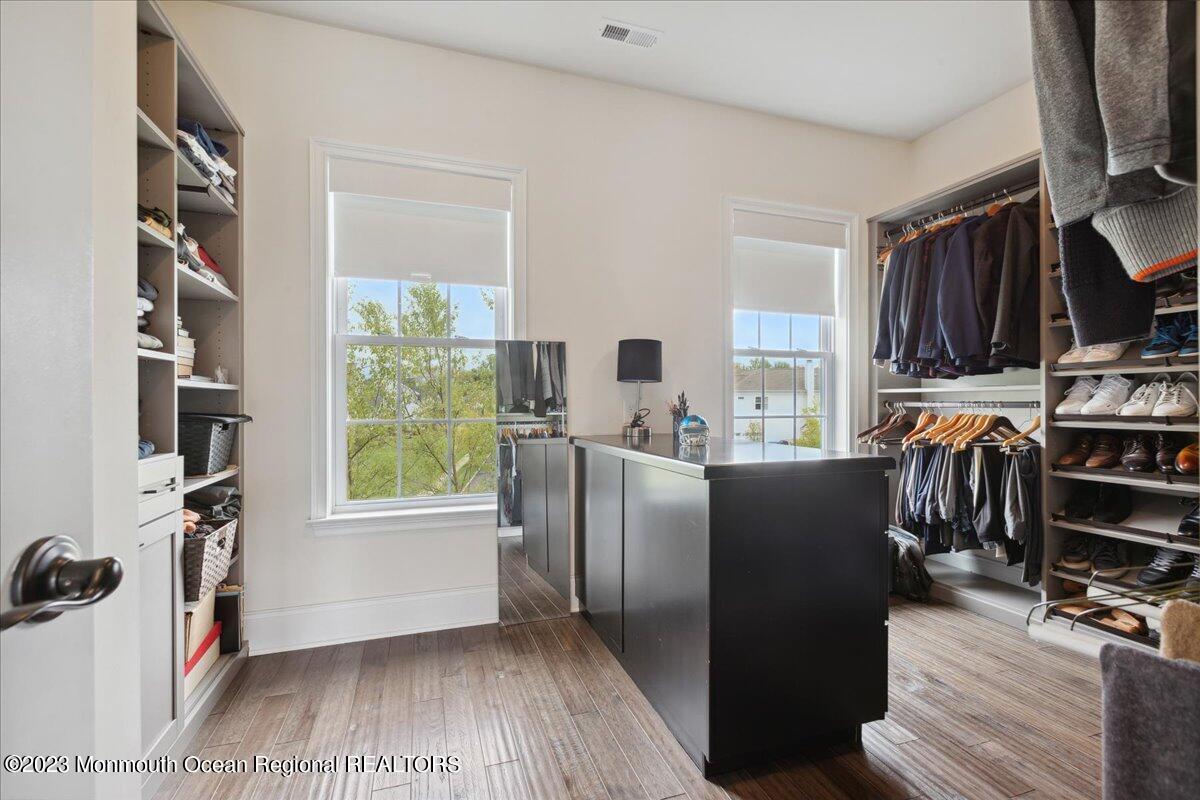 25 Windermere Road Lincroft, NJ 07738 - Photo 35 of 70 a view of kitchen and dining room with wooden floor and a window