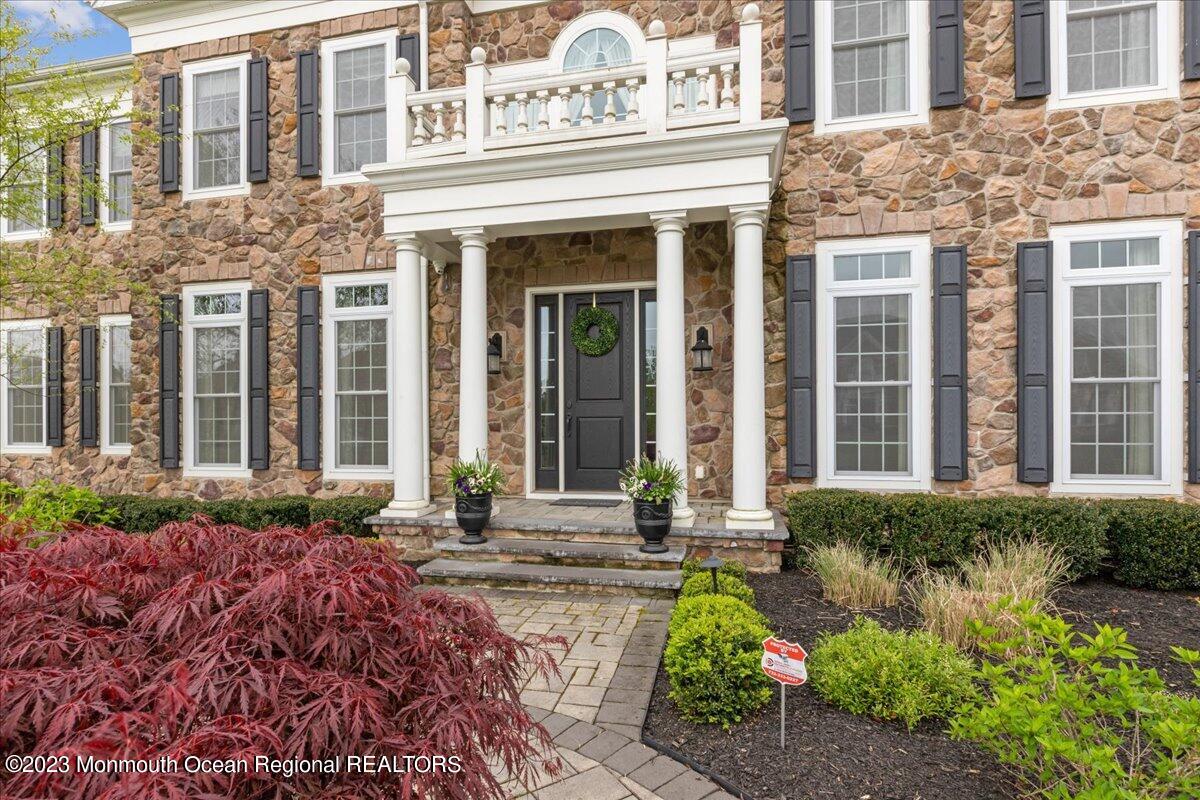 25 Windermere Road Lincroft, NJ 07738 - Photo 4 of 70 front view of a brick house with a yard