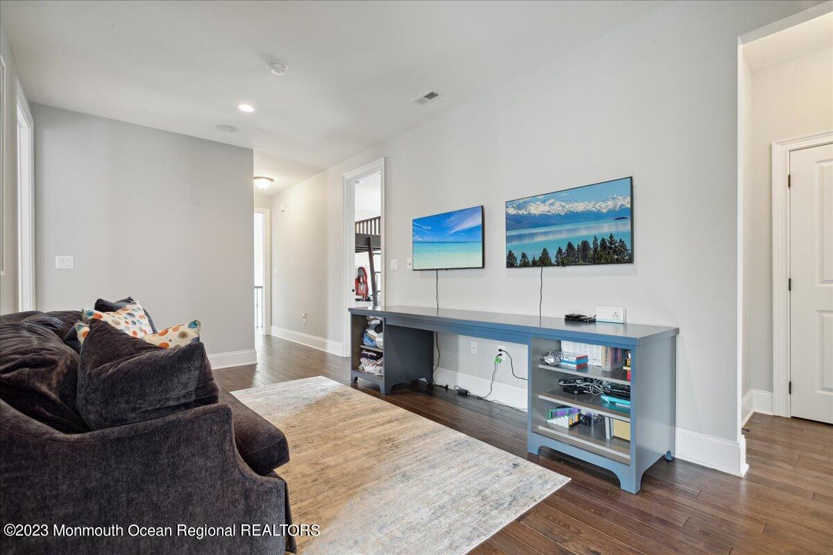 25 Windermere Road Lincroft, NJ 07738 - Photo 41 of 70 a living room with furniture and a wooden floor
