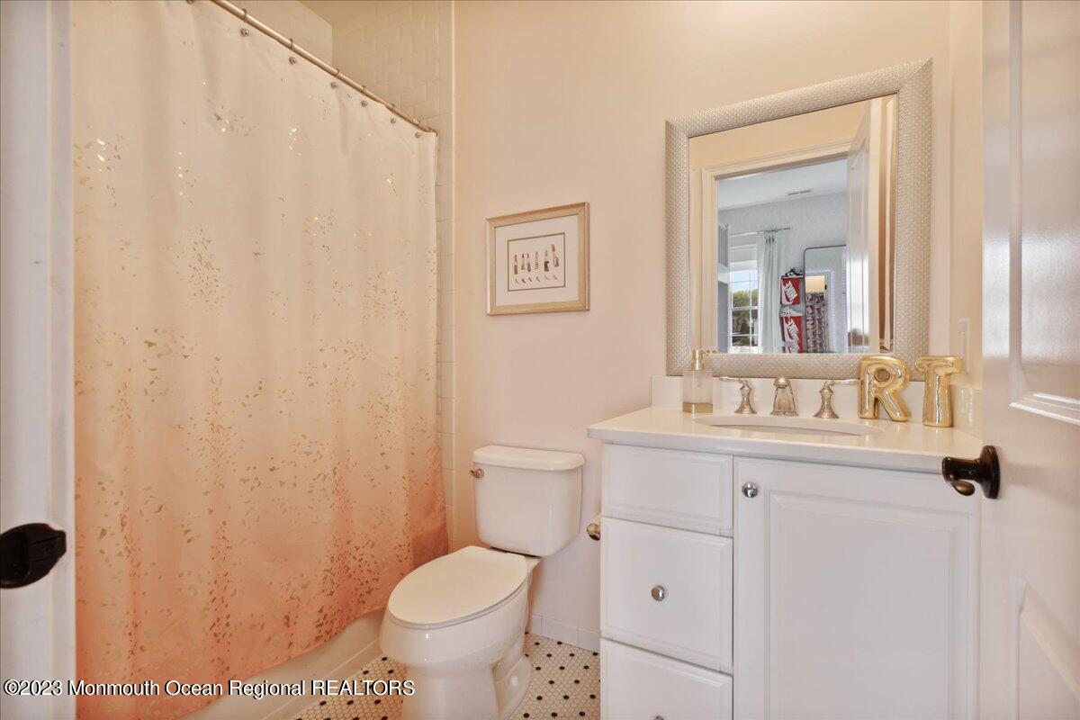 25 Windermere Road Lincroft, NJ 07738 - Photo 43 of 70 a bathroom with a toilet a sink and mirror