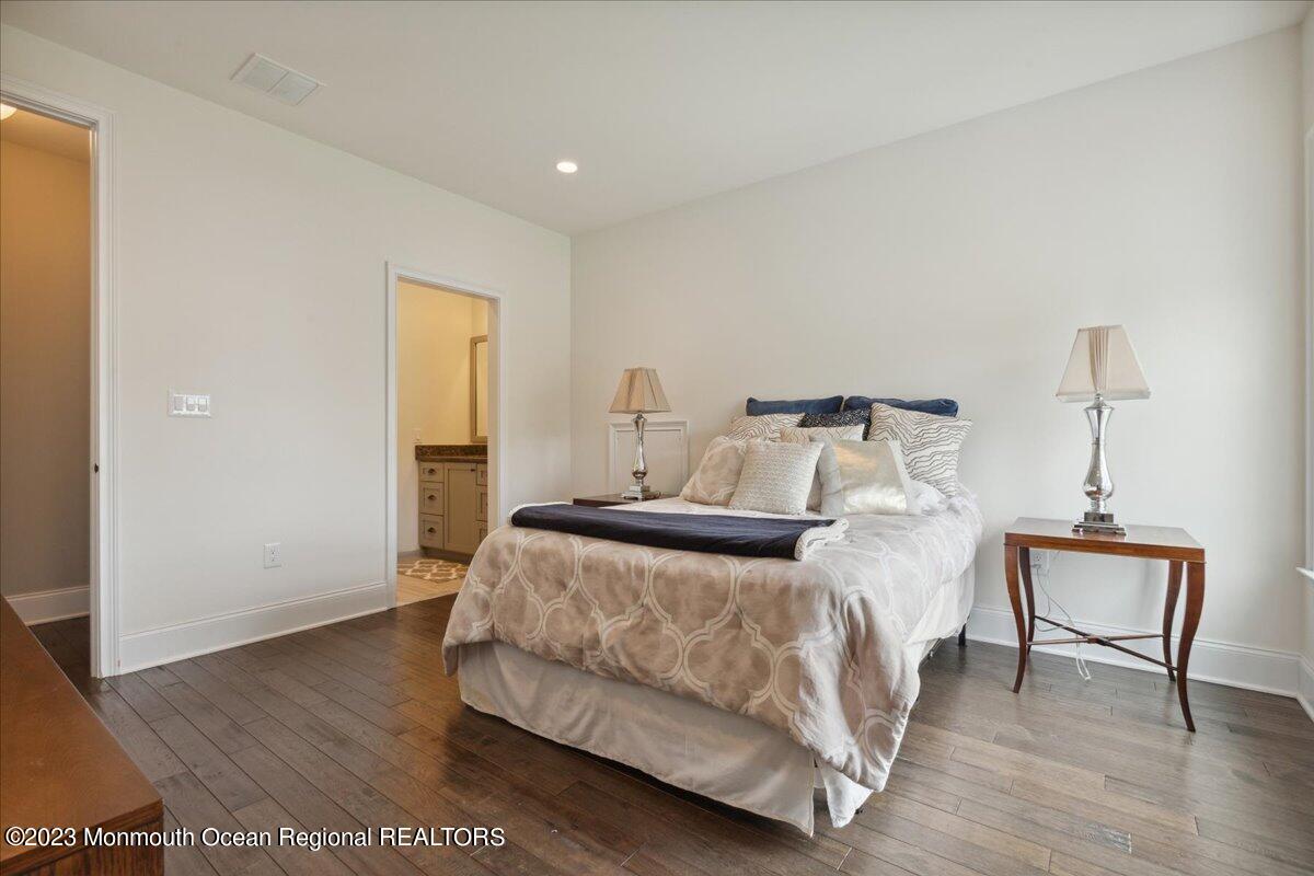 25 Windermere Road Lincroft, NJ 07738 - Photo 46 of 70 a bedroom with a bed and wooden floor