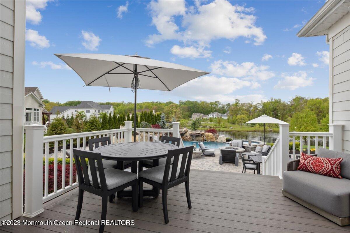 25 Windermere Road Lincroft, NJ 07738 - Photo 52 of 70 an outdoor space with furniture and umbrella