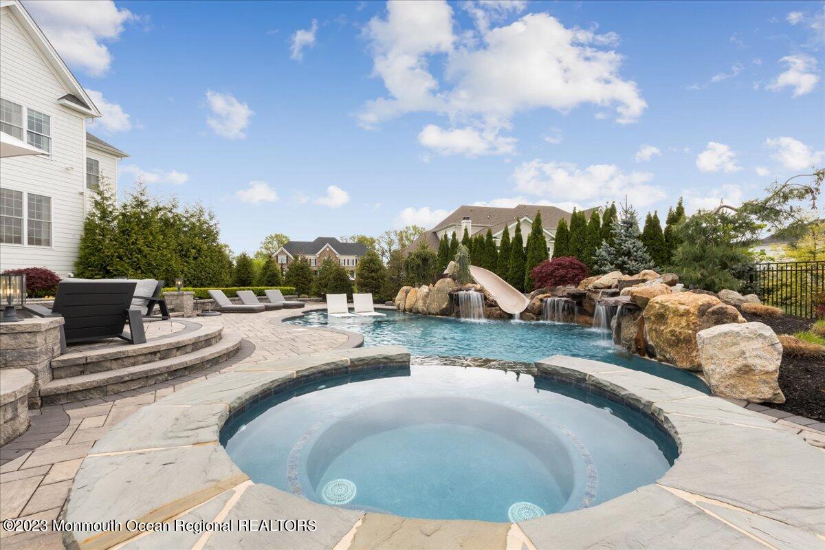 25 Windermere Road Lincroft, NJ 07738 - Photo 60 of 70 a view of a swimming pool and lounge chairs