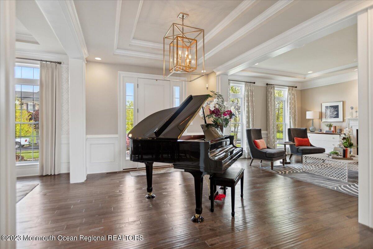 25 Windermere Road Lincroft, NJ 07738 - Photo 6 of 70 a living room with dining room wooden floor and a chandelier
