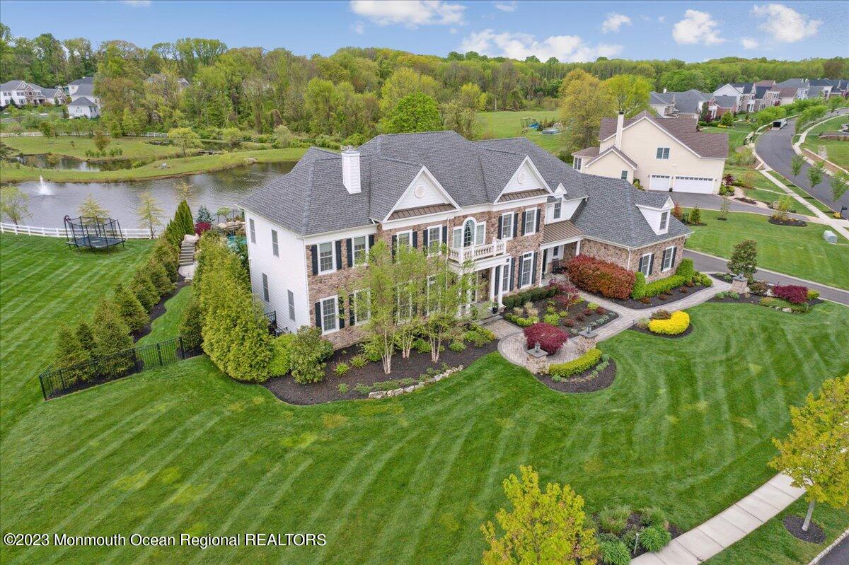 25 Windermere Road Lincroft, NJ 07738 - Photo 63 of 70 a view of a big house with a big yard and large trees