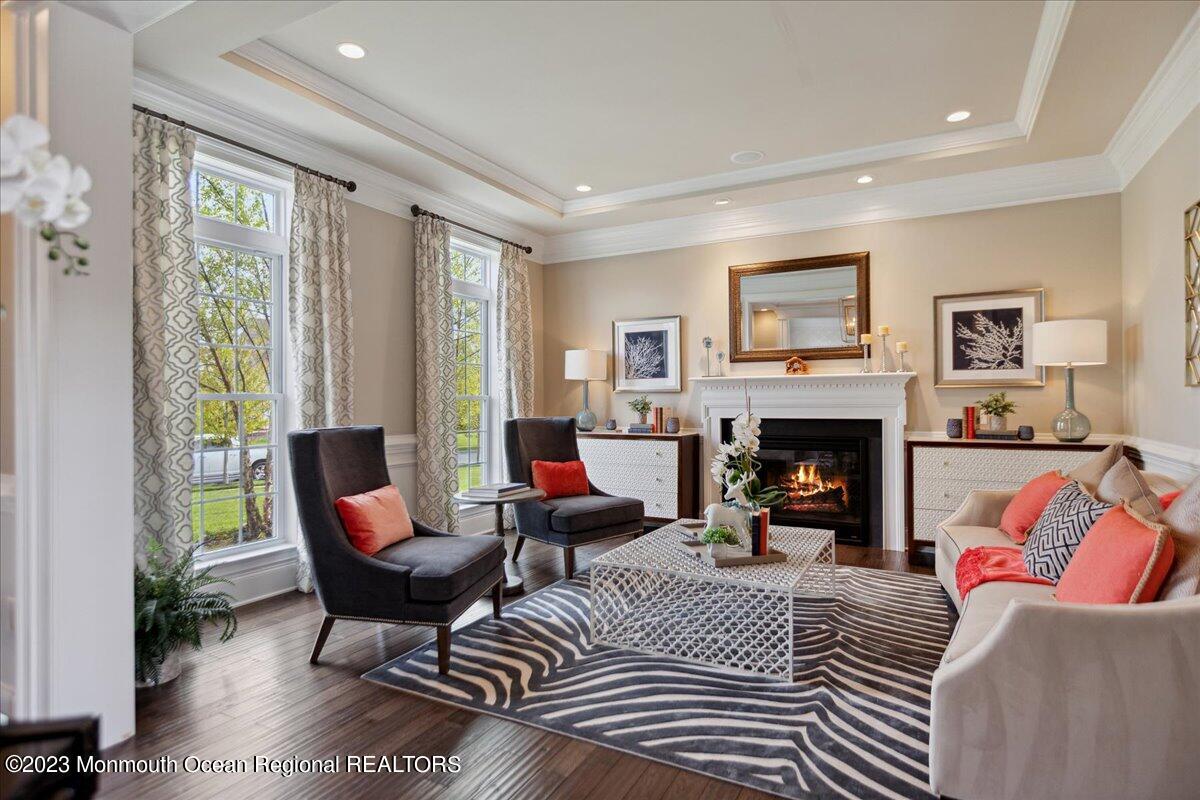 25 Windermere Road Lincroft, NJ 07738 - Photo 10 of 70 a living room with furniture and a fireplace