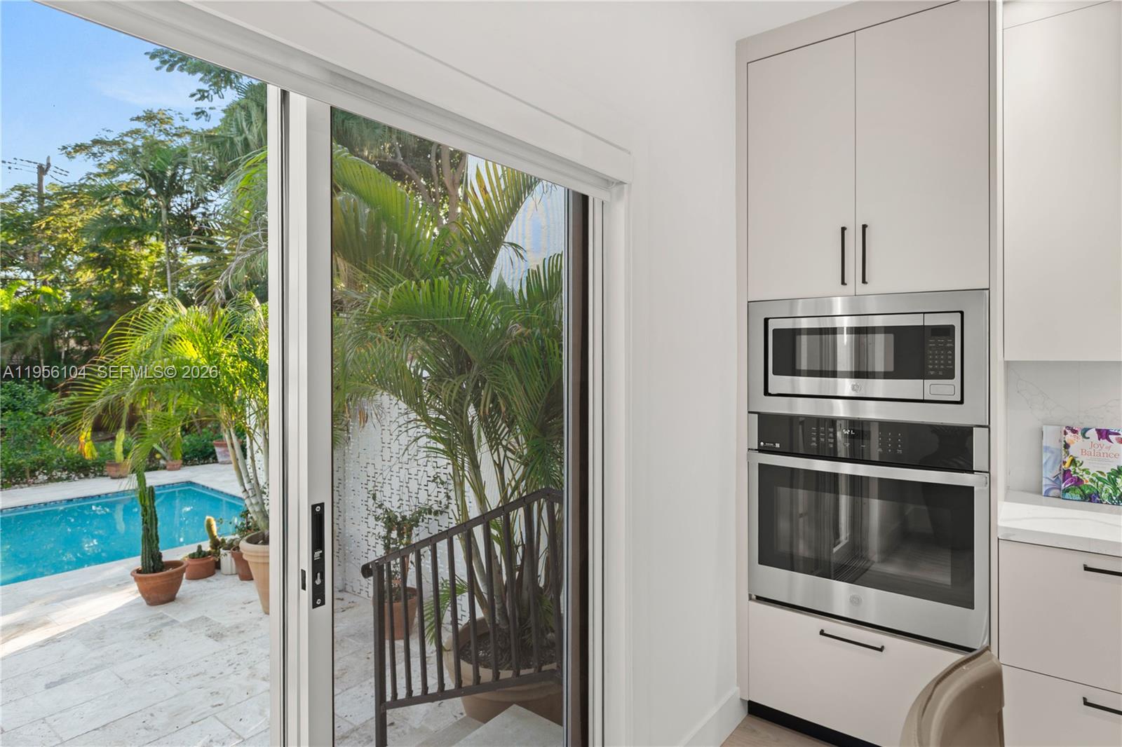 3616 Southwest 26th Street Miami, FL 33133 - Photo 17 of 77 a view of a porch with furniture and floor to ceiling window