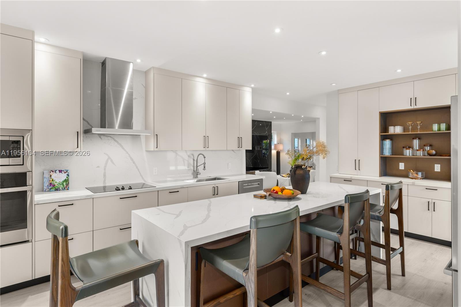 3616 Southwest 26th Street Miami, FL 33133 - Photo 18 of 77 a kitchen with a dining table chairs and white appliances