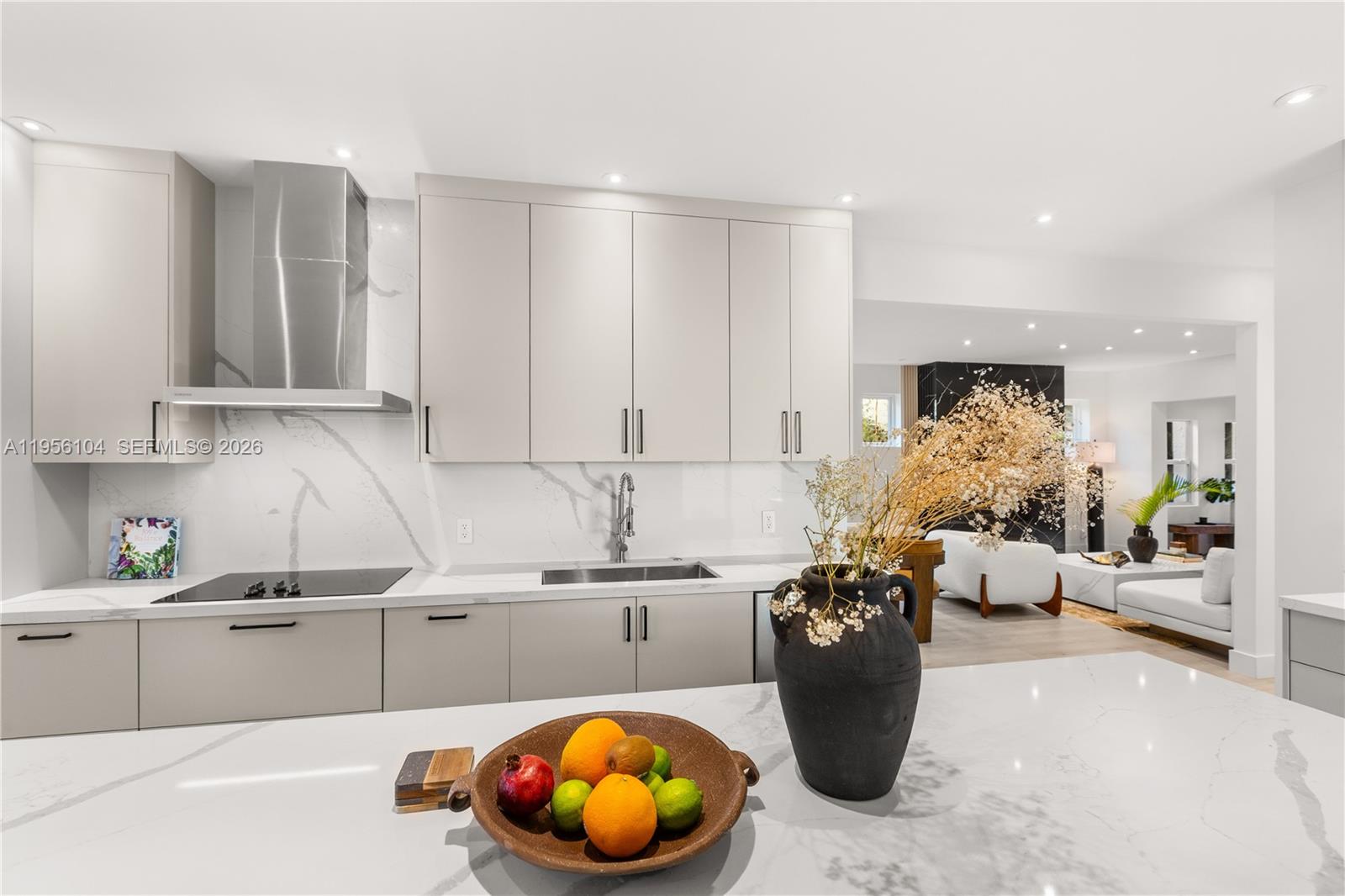 3616 Southwest 26th Street Miami, FL 33133 - Photo 19 of 77 a kitchen with a sink and dishwasher a stove top oven with wooden floor