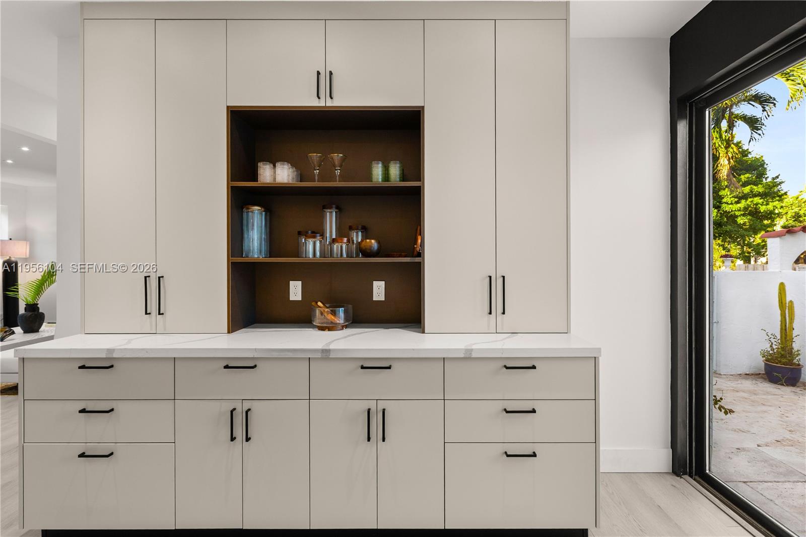 3616 Southwest 26th Street Miami, FL 33133 - Photo 31 of 77 a kitchen with white cabinets and a wooden floor