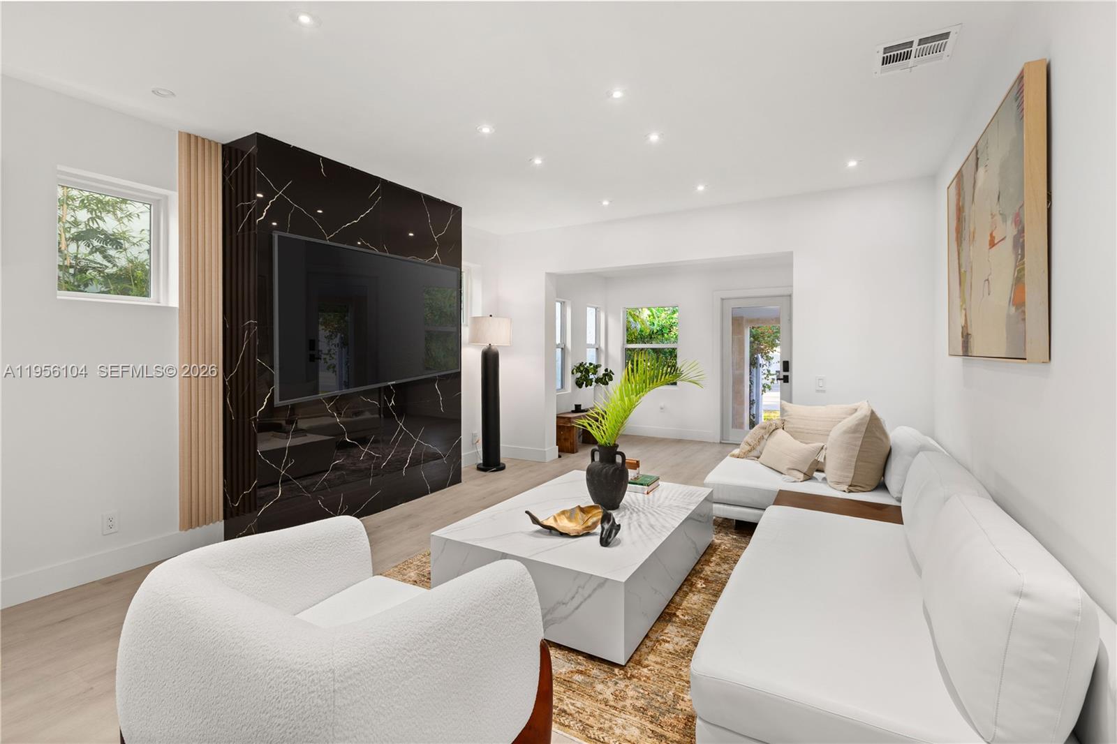 3616 Southwest 26th Street Miami, FL 33133 - Photo 33 of 77 a living room with furniture potted plant and a flat screen tv