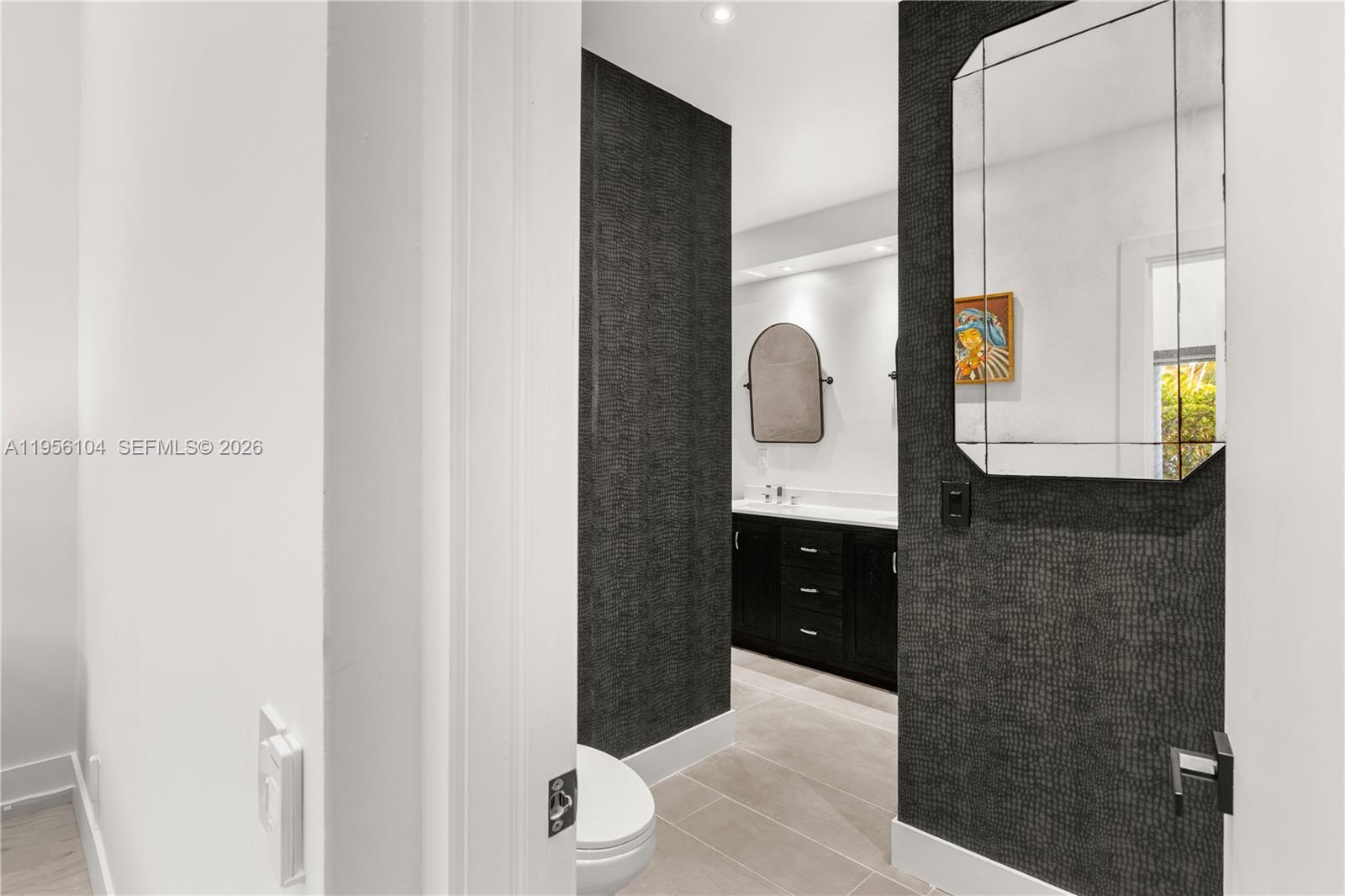 3616 Southwest 26th Street Miami, FL 33133 - Photo 42 of 77 a bathroom with a granite countertop sink and a mirror