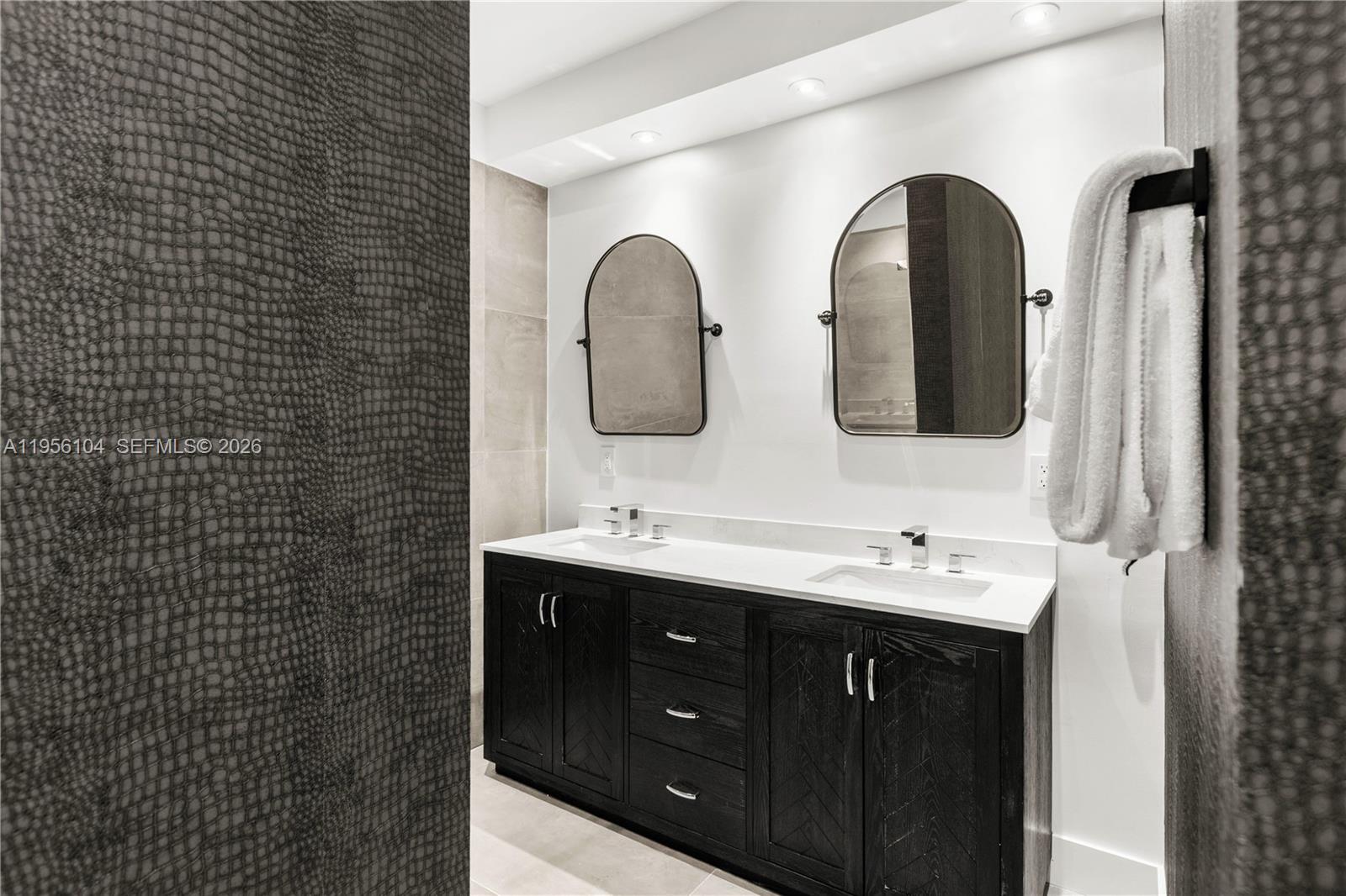 3616 Southwest 26th Street Miami, FL 33133 - Photo 43 of 77 a bathroom with a double vanity sink and a mirror