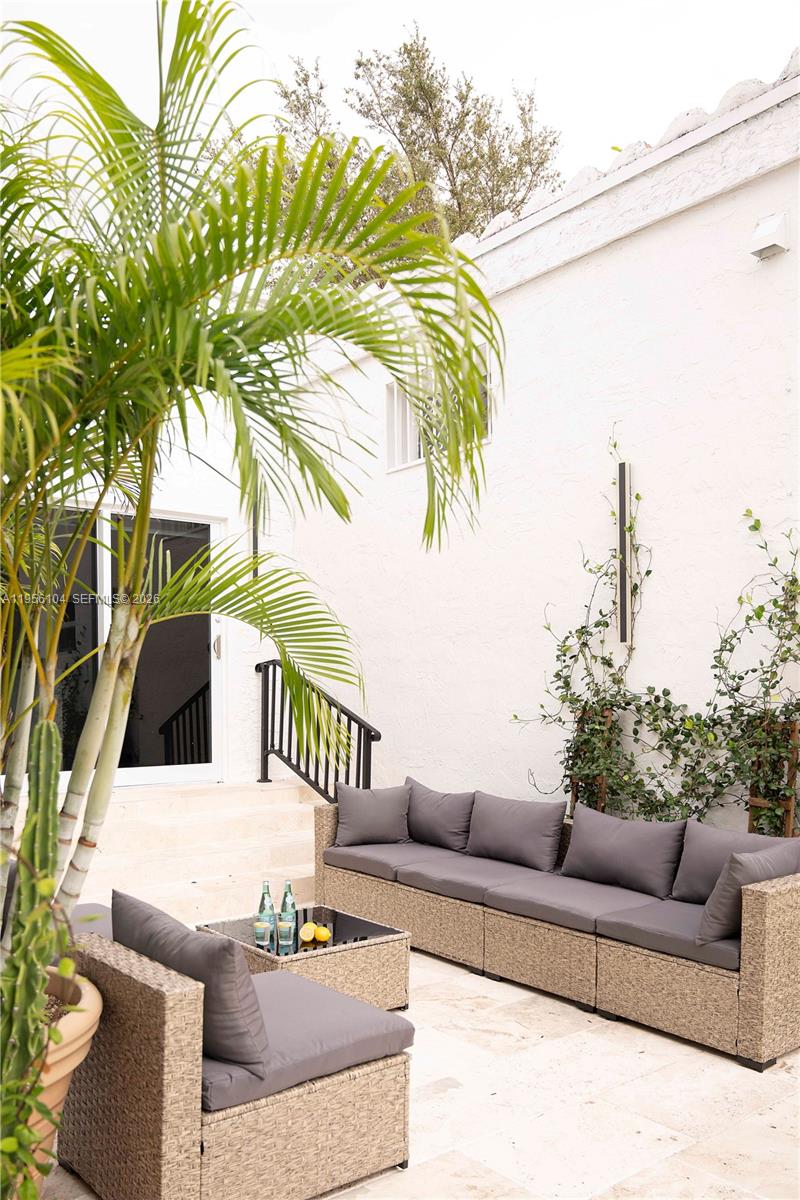 3616 Southwest 26th Street Miami, FL 33133 - Photo 62 of 77 a view of a patio with couches and a potted plant on a table