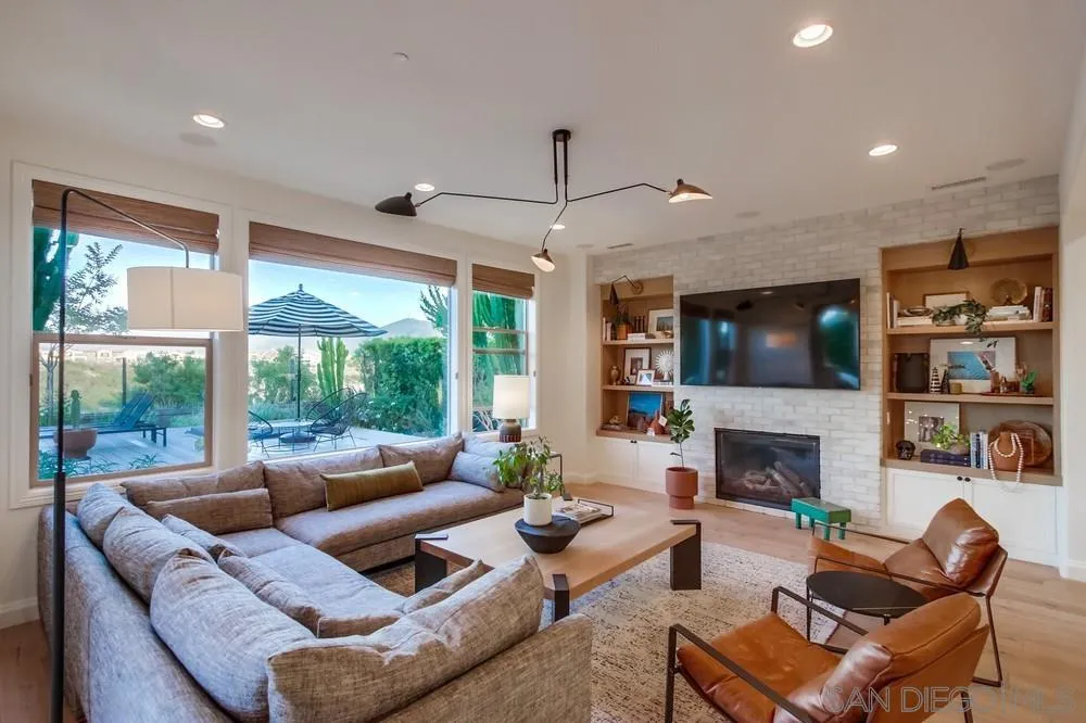 15497 Tanner Ridge Road San Diego, CA 92127 - Photo 20 of 48 a living room with furniture fireplace and a flat screen tv