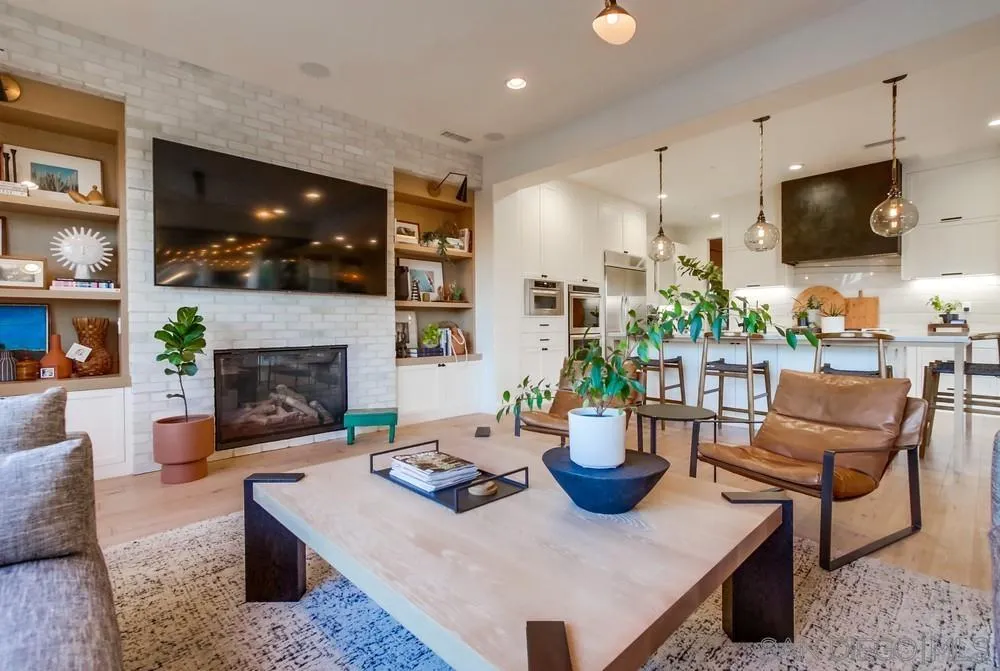 15497 Tanner Ridge Road San Diego, CA 92127 - Photo 21 of 48 a living room with furniture a flat screen tv and a fireplace