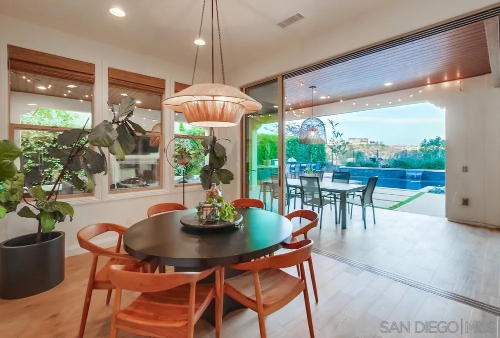 15497 Tanner Ridge Road San Diego, CA 92127 - Photo 23 of 48 a dining room with furniture a chandelier and garden