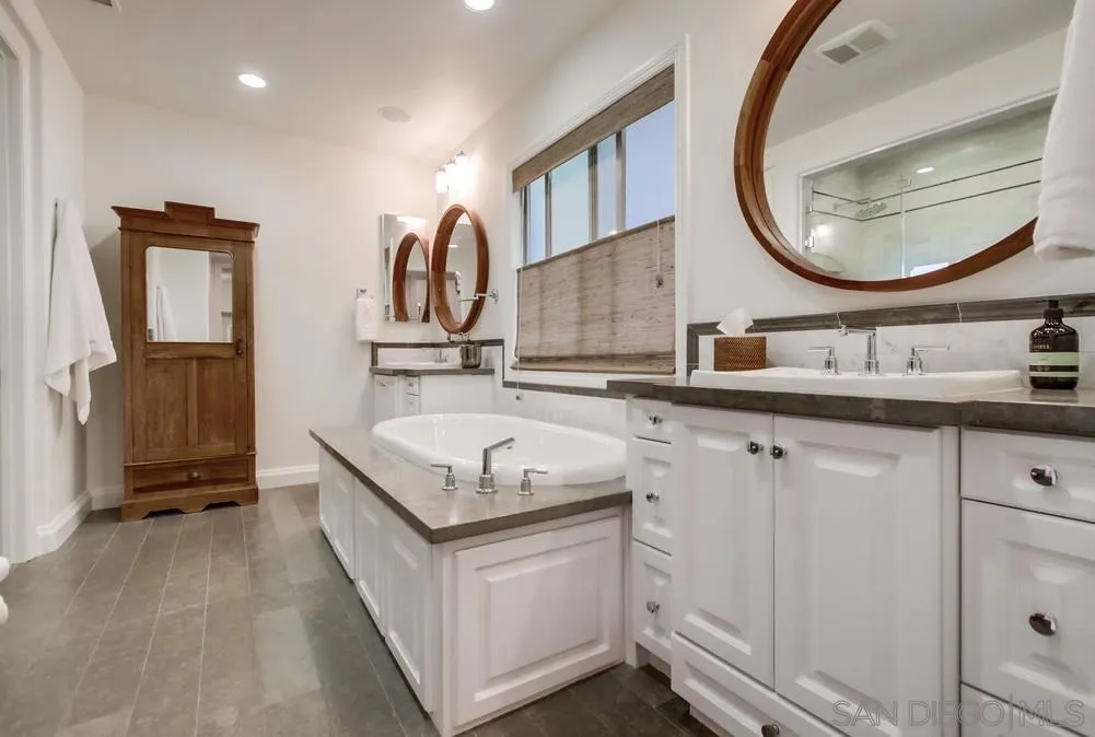 15497 Tanner Ridge Road San Diego, CA 92127 - Photo 35 of 48 a en suite bathroom with a sink and a mirror