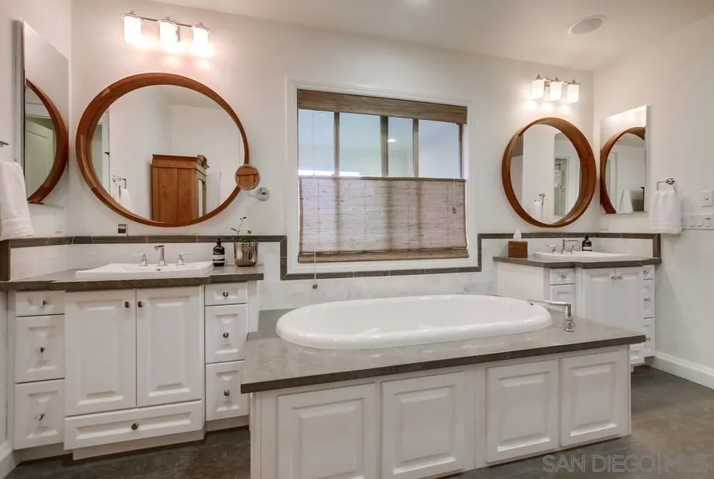 15497 Tanner Ridge Road San Diego, CA 92127 - Photo 37 of 48 a bathroom with a granite countertop double vanity sink and a mirror