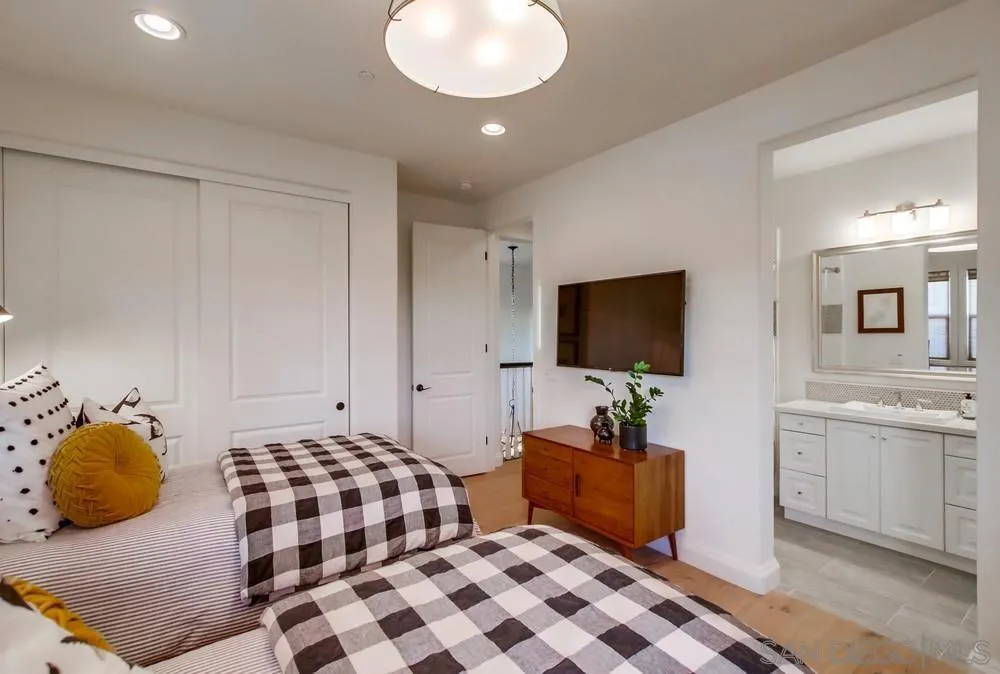 15497 Tanner Ridge Road San Diego, CA 92127 - Photo 40 of 48 a bedroom with a bed and flat screen tv