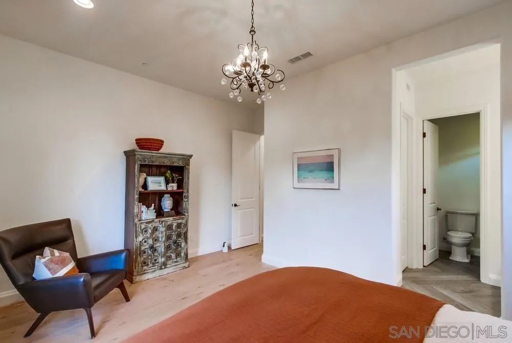 15497 Tanner Ridge Road San Diego, CA 92127 - Photo 42 of 48 a bedroom with a bed and a chair