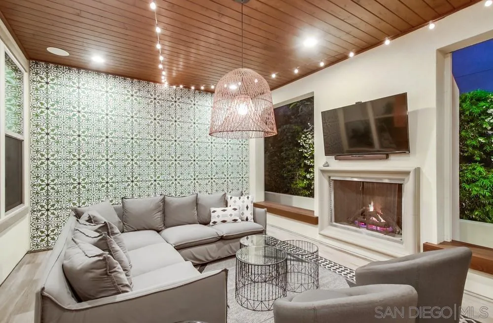 15497 Tanner Ridge Road San Diego, CA 92127 - Photo 9 of 48 a living room with furniture a fireplace and a flat screen tv