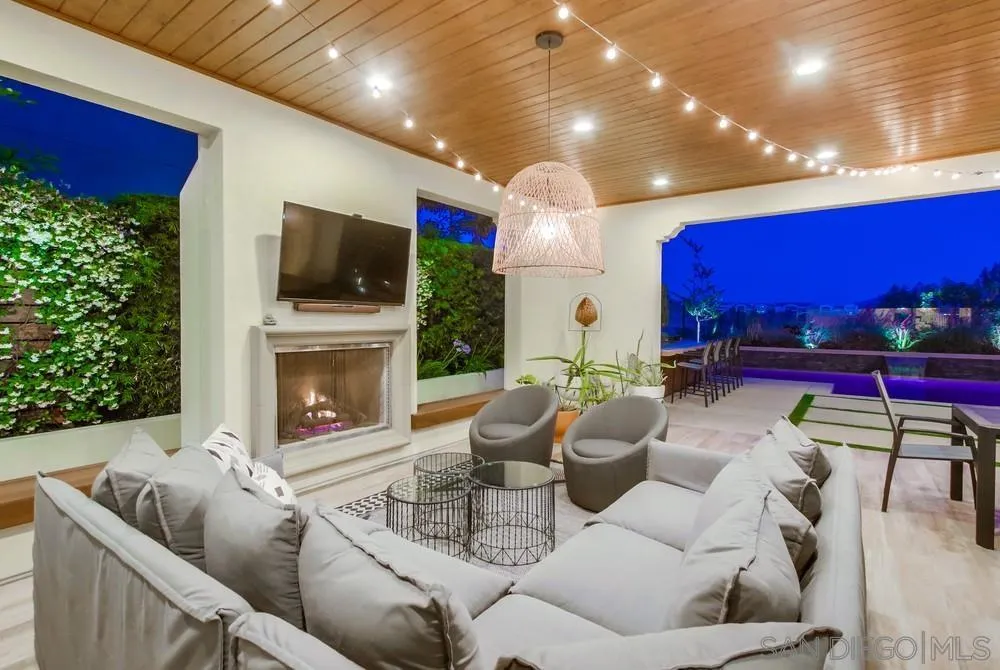 15497 Tanner Ridge Road San Diego, CA 92127 - Photo 10 of 48 a living room with furniture a flat screen tv and a fireplace