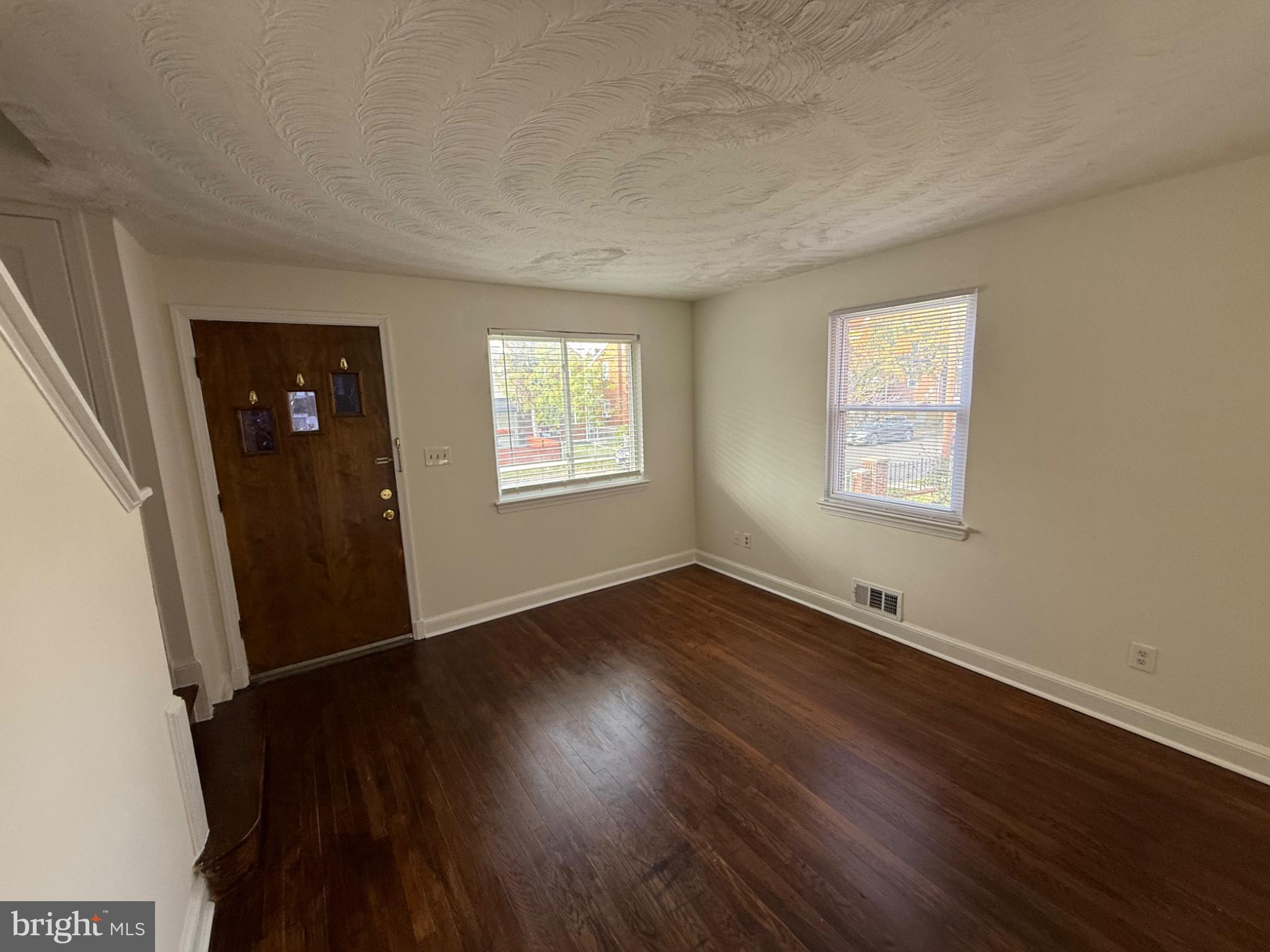 374 Chaplin Street Southeast Washington, DC 20019 - Photo 14 of 23 an empty room with wooden floor and windows