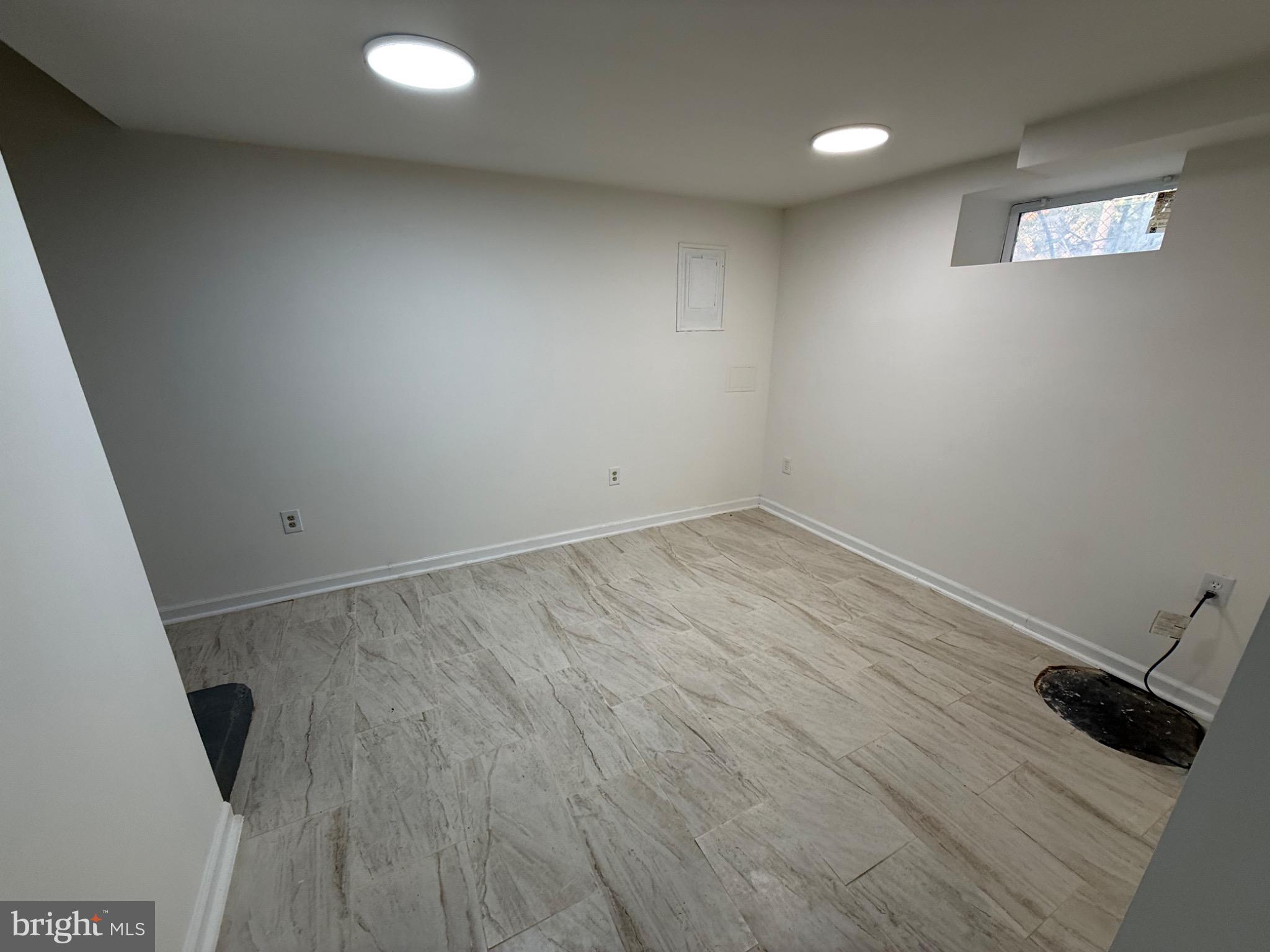 374 Chaplin Street Southeast Washington, DC 20019 - Photo 21 of 23 an empty room with wooden floor and sink