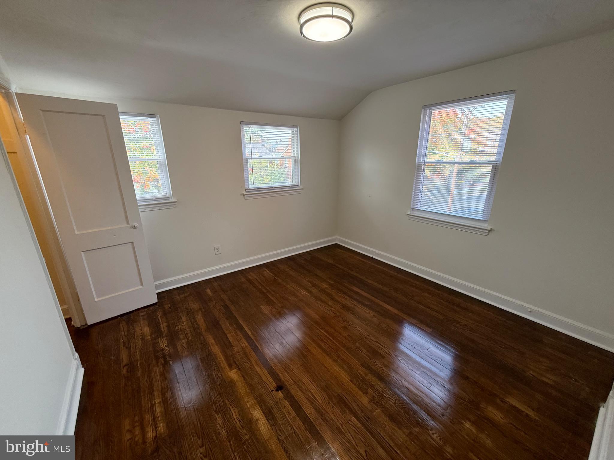 374 Chaplin Street Southeast Washington, DC 20019 - Photo 3 of 23 a view of an empty room with wooden floor and a window