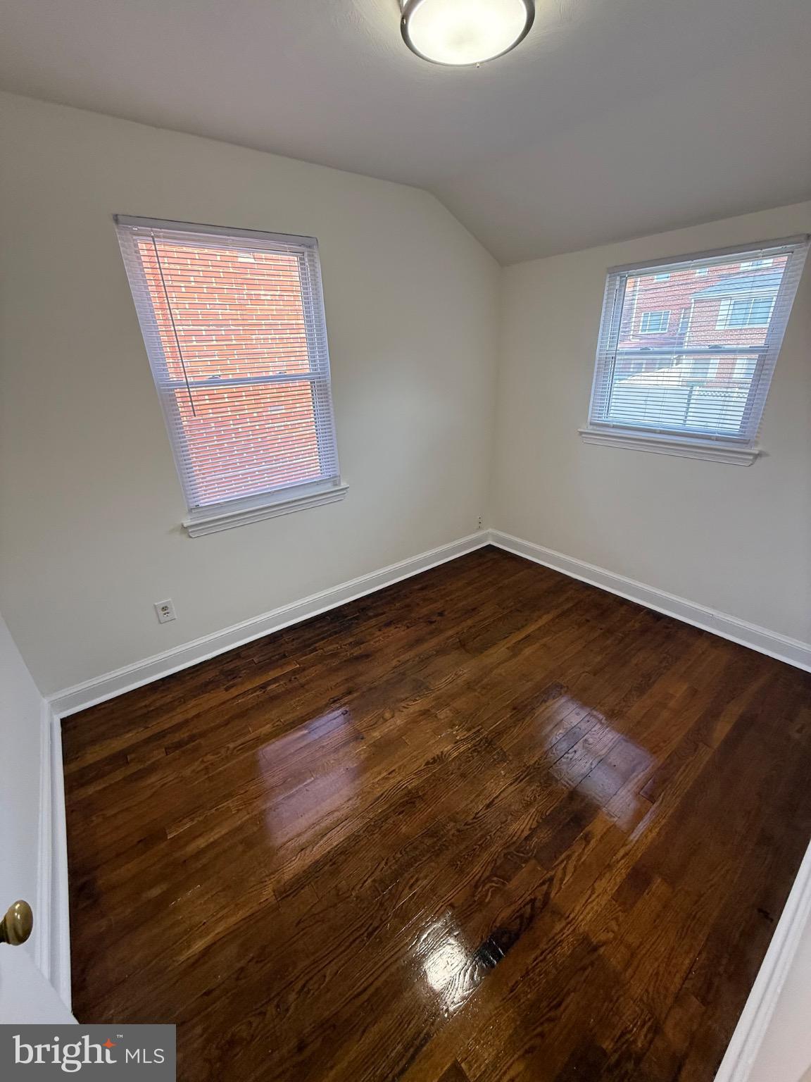 374 Chaplin Street Southeast Washington, DC 20019 - Photo 4 of 23 a view of an empty room with wooden floor and a window