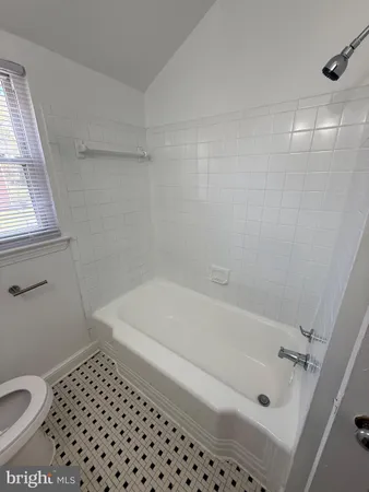 a bathroom with a bathtub and a toilet