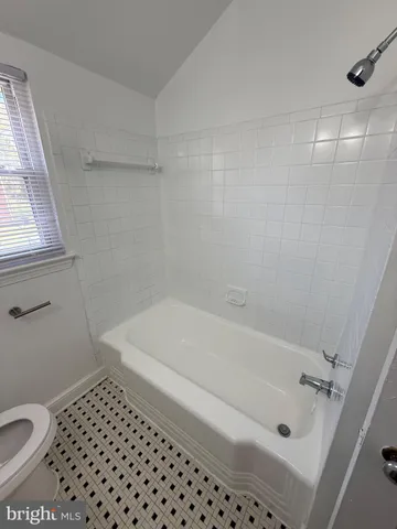 a bathroom with a bathtub and a toilet