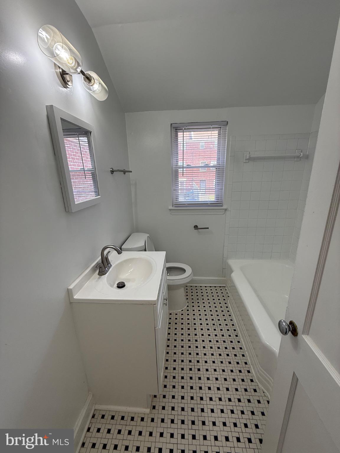 374 Chaplin Street Southeast Washington, DC 20019 - Photo 7 of 23 a bathroom with a sink a toilet a mirror and shower