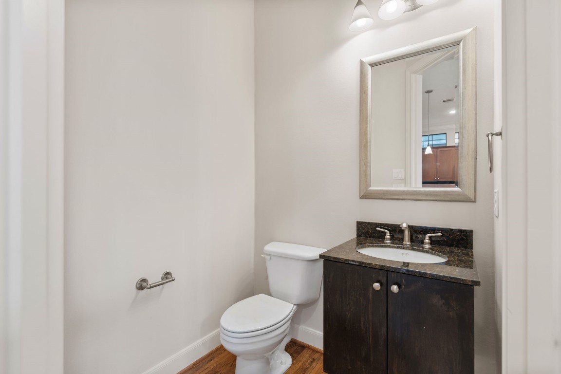 121 Roy Street Houston, TX 77007 - Photo 11 of 33 a bathroom with a granite countertop toilet sink and mirror