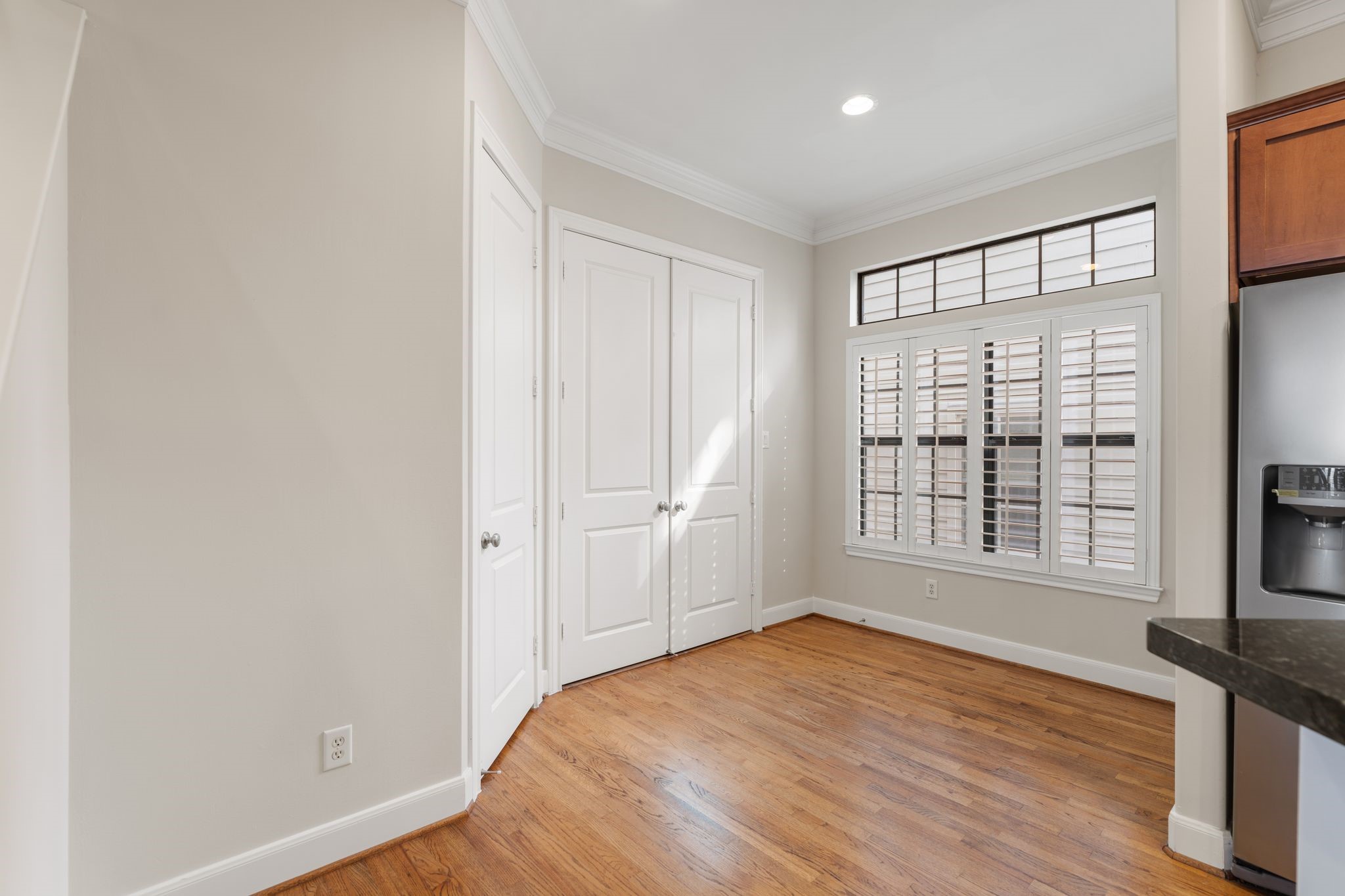 121 Roy Street Houston, TX 77007 - Photo 11 of 29 Bright and inviting space with hardwood floors, a large window with plantation shutters, and modern recessed lighting. Ideal for a cozy dining or sitting area adjacent to the kitchen.