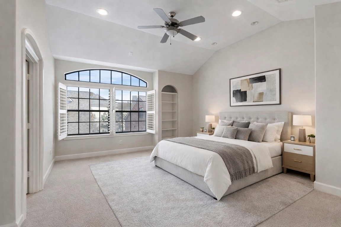 121 Roy Street Houston, TX 77007 - Photo 13 of 33 a spacious bedroom with a large bed and a chandelier