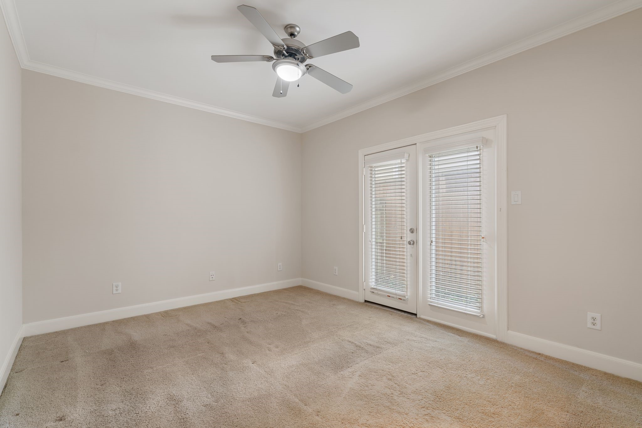 121 Roy Street Houston, TX 77007 - Photo 14 of 29 This room features neutral-toned walls, a ceiling fan, and French doors to backyard. T